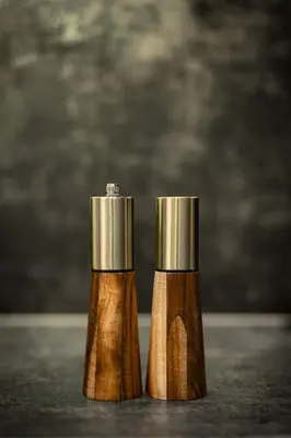 two wooden salt and pepper shakers sitting next to each other at VINTAGE SENACKA APARTMENTS in Kraków