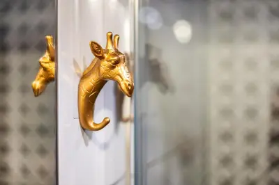 a door knob with a gold giraffe head on it at VINTAGE SENACKA APARTMENTS in Kraków