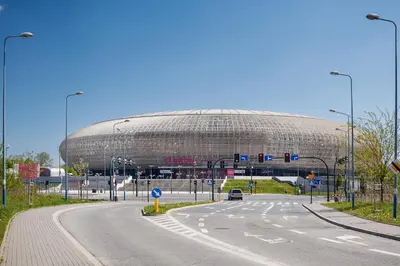 a large round building in the middle of a road at Tauron Arena Elegant Apartment Dąbska by Noclegi Renters in Kraków