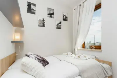 a white bedroom with a bed and a window at Tauron Arena Elegant Apartment Dąbska by Noclegi Renters in Kraków