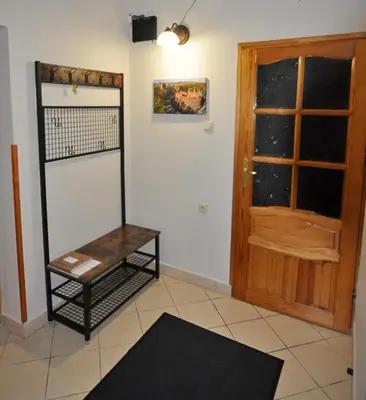 a room with a wooden door and a table at Cracow Family House in Kraków