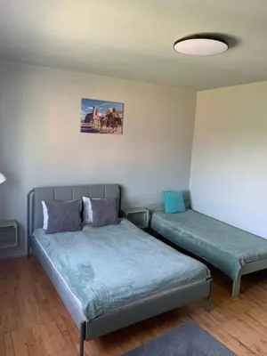 a bedroom with two beds and a ceiling at Cracow Family House in Kraków