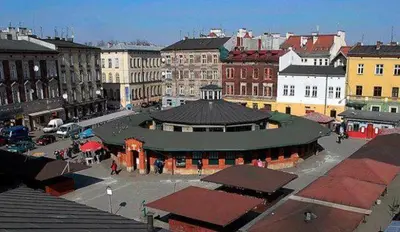 a city with a building in the middle of a street at Beautiful apartment with air conditioning, balcony and underground garage in Kraków