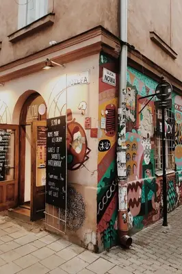 a building with a mural on the side of it at Beautiful apartment with air conditioning, balcony and underground garage in Kraków