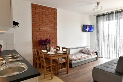 a kitchen and living room with a table and a couch at ANGELS A in Zator