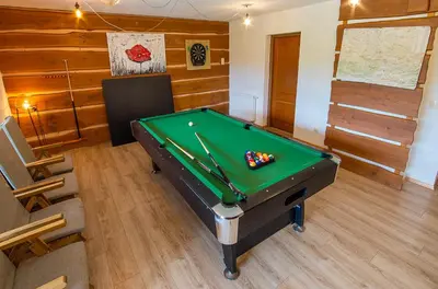 a room with a pool table in a room at Tarnawianka Apart, jacuzzi, sauna, bilard in Tarnawa Górna