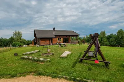 a log cabin with a playground in front of it at Tarnawianka Apart, jacuzzi, sauna, bilard in Tarnawa Górna