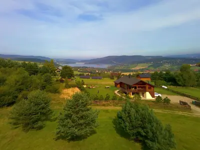 an aerial view of a house in a green field at Tarnawianka Apart, jacuzzi, sauna, bilard in Tarnawa Górna