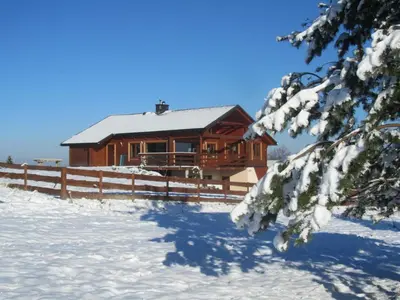 a log cabin in the snow with a fence at Tarnawianka Apart, jacuzzi, sauna, bilard in Tarnawa Górna