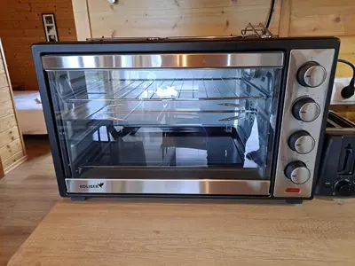 a toaster oven with its door open in a kitchen at Tarnawianka Apart, jacuzzi, sauna, bilard in Tarnawa Górna
