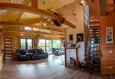 a living room with leather furniture and wooden ceilings at Tarnawianka Apart, jacuzzi, sauna, bilard in Tarnawa Górna