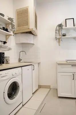 a white kitchen with a washing machine in it at Cozy Studio perfect for couples, Cracow Old Town in Kraków