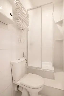 a white bathroom with a toilet and a shower at Cozy Studio perfect for couples, Cracow Old Town in Kraków