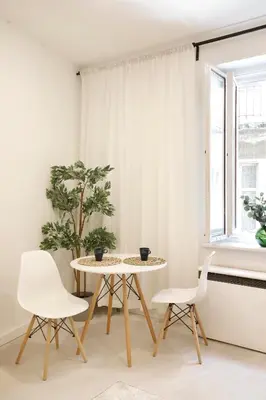 a table and two chairs in a room with a window at Cozy Studio perfect for couples, Cracow Old Town in Kraków