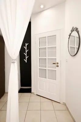 a room with a white door and a mirror at Cozy Studio perfect for couples, Cracow Old Town in Kraków