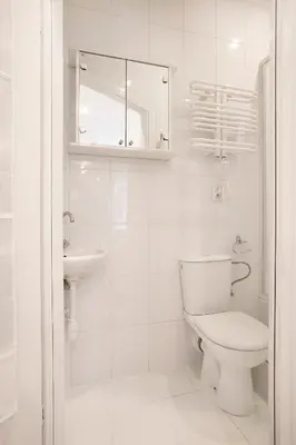 a white bathroom with a toilet and a sink at Cozy Studio perfect for couples, Cracow Old Town in Kraków