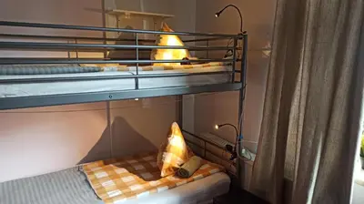 a room with a bunk bed with two bunk beds with at Willa Retro Hostel & Garden in Kraków