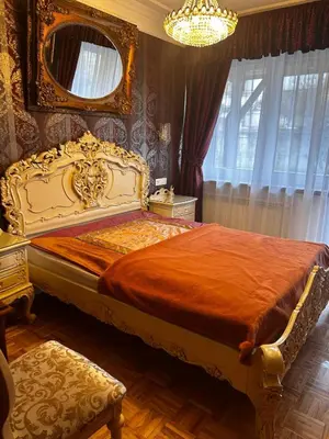 a bedroom with a bed and a chandelier at Cracow. Villa Cherubin Garden in Kraków