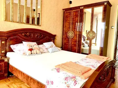 a bedroom with a bed with a teddy bear on it at Cracow. Villa Cherubin Garden in Kraków