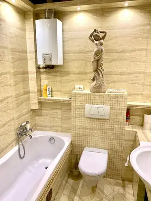 a bathroom with a tub and a toilet and a sink at Cracow. Villa Cherubin Garden in Kraków