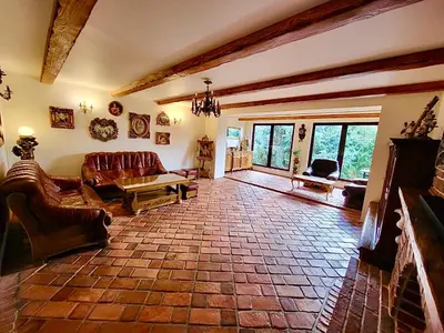 a living room with leather furniture and a stone floor at Cracow. Villa Cherubin Garden in Kraków