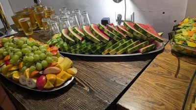 two plates of fruit on a wooden table at Greg&Tom Beer House Hostel in Kraków