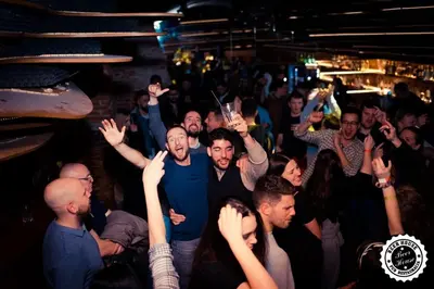a group of people in a crowd at a party at Greg&Tom Beer House Hostel in Kraków
