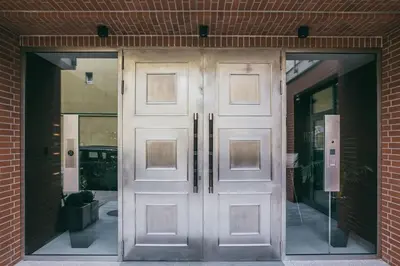 a pair of doors in a brick building at Harmo Old Town with Spacious Sunny Terrace in Kraków