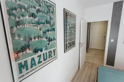 a large painting of a golf course on a wall at Nica Old Town Free Parking Spacious Sunny Terrace in Kraków