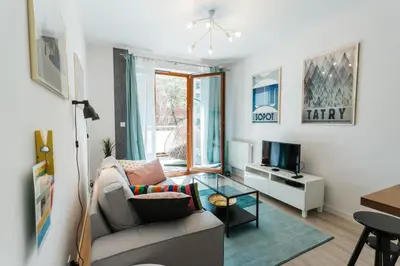 a living room with a couch and a tv at Nica Old Town Free Parking Spacious Sunny Terrace in Kraków