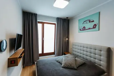 a bedroom with a bed and a window at Harmonica Old Town with Free Parking in Kraków