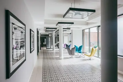 a hallway with chairs and pictures on the walls at Harmonica Old Town with Free Parking in Kraków