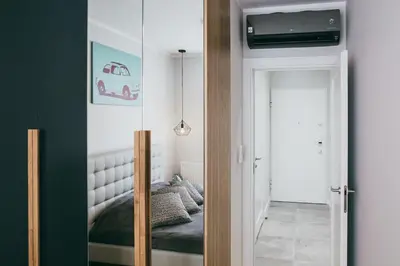 a bedroom with a bed and a mirror in a room at Harmonica Old Town with Free Parking in Kraków