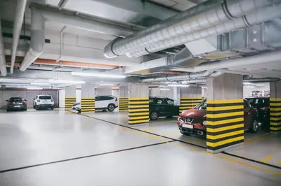 a parking garage with several cars parked in it at Harmonica Old Town with Free Parking in Kraków