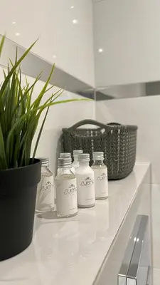 a group of milk bottles sitting on a counter in a bathroom at Presto by Housine,pl Zator in Zator