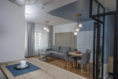 a living room with a couch and a table at Ermine Suites in Kraków