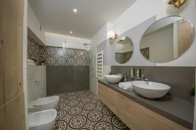 a bathroom with two sinks and two toilets at Ermine Suites in Kraków