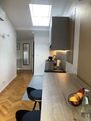 a kitchen with a wooden counter top in a room at Ermine Suites in Kraków