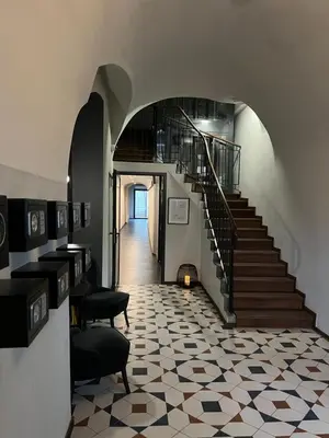 a hallway with a staircase and a floor with a fireplace at Ermine Suites in Kraków
