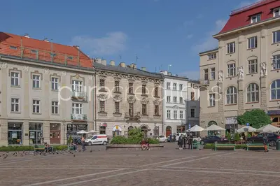 a group of buildings in a square in a city at Ermine Suites in Kraków