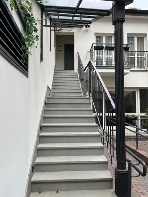 a set of stairs leading up to a building at Ermine Suites in Kraków