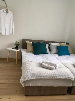 a bedroom with two beds with blue and white pillows at Apartament 212 in Klikuszowa