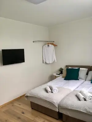 a bedroom with two beds and a flat screen tv at Apartament 212 in Klikuszowa