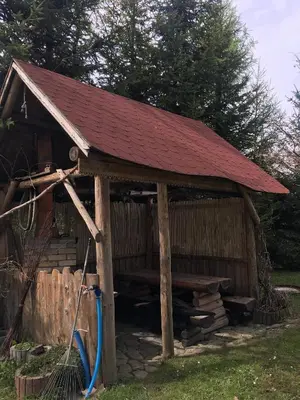 a wooden cabin with a red roof at Apartament 212 in Klikuszowa