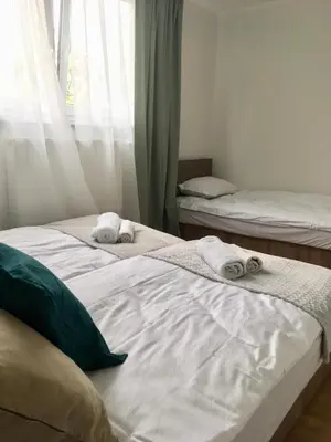 two beds with towels on them in a bedroom at Apartament 212 in Klikuszowa