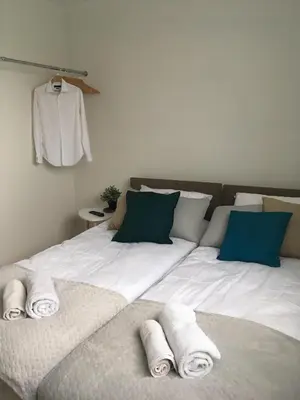 a bedroom with a large bed with towels on it at Apartament 212 in Klikuszowa