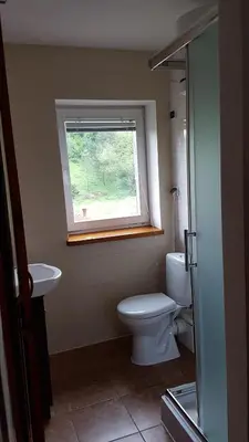 a bathroom with a toilet and a window at Gospodarstwo Agroturystyczne Dolina Zachwytu in Sułoszowa