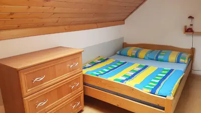 a bedroom with a bunk bed and a dresser at Gospodarstwo Agroturystyczne Dolina Zachwytu in Sułoszowa