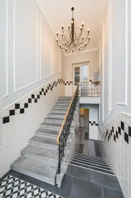 a staircase in a room with a chandelier at Art of Serenity in Kraków