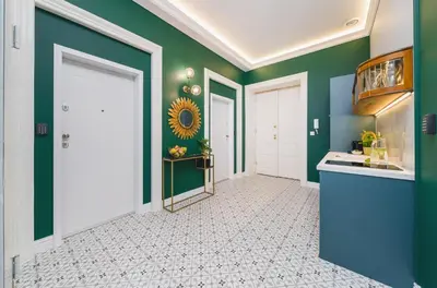 a hallway of a home with green walls at Art of Serenity in Kraków